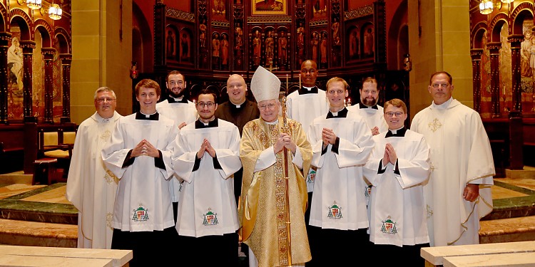 From Left to Right: Father Benedict O’Cinnsealaigh, Christopher Komoroski, Jeremy Stubbs, David Carvajal Casal, Ryan Furlong, Bishop Emeritus Edward J. Slattery, Benson Lokidiriyo, Robert Healey, Andrew Reckers, Kirby Rust and Father Anthony Brausch. (Photo by E L Hubbard)