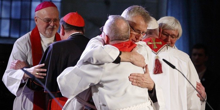 The Rev. Martin Junge, general secretary of the Lutheran World Federation, embraces Bishop Munib Younan of the Evangelical Lutheran Church, president of the Lutheran World Federation, front center, during an ecumenical prayer service at the Lutheran cathedral in Lund, Sweden, Oct. 31. At right, Pope Francis embraces Archbishop Antje Jackelen, primate of the Lutheran Church in Sweden. At left is Bishop Anders Arborelius of Stockholm and Cardinal Kurt Koch, president of the Pontifical Council for Promoting Christian Unity. (CNS photo/Paul Haring)