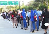 Hundreds of people fanned out on the pavement at the beginning of the Eucharistic procession route, kneeling when the procession passed them and then standing to join in until all the participants were walking the one-mile route. (CT Photo/Gail Finke)