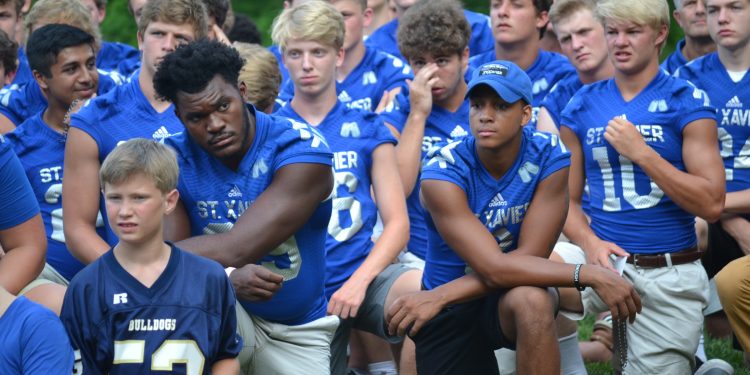 St. Xavier Bombers take a knee in prayer (CT Photo/Gail Finke)