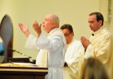 The pastor, Father Jim Manning, prays with Archbishop Dennis J. Schnurr at the Mass celebrating the parish’s 150th anniversary and the new church building’s first anniversary. (CT Photo/Jeff Unroe)