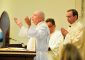 The pastor, Father Jim Manning, prays with Archbishop Dennis J. Schnurr at the Mass celebrating the parish’s 150th anniversary and the new church building’s first anniversary. (CT Photo/Jeff Unroe)