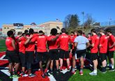 Students gather at the 50 yard line to read the Stations of the Cross and then do 40 seconds of conditioning after each Station is read. (CT Photo/Greg Hartman)