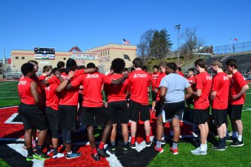 Students gather at the 50 yard line to read the Stations of the Cross and then do 40 seconds of conditioning after each Station is read. (CT Photo/Greg Hartman)