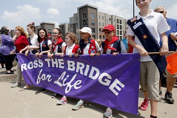 American Heritage Girls carry the banner during the Cross the Bridge for Life in Newport, Ky. Sunday, June 2, 2019. (CT Photo/E.L. Hubbard)