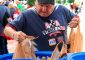 St. Vincent de Paul volunteer Steve Taylor places bags of donated food into a collection bin outside of Great American Ballpark on Friday, May 31. SVdP collected food from patrons of the Reds games on Friday and Saturday, May 31 and June 1, during their “Strike Out Hunger" campaign. Game patrons who donated three or more non-perishable foods were awarded tickets to a future Reds game. Last year’s drive collected over three tons of food, which fed approximately 5,300 families. (CT photo/David A. Moodie)